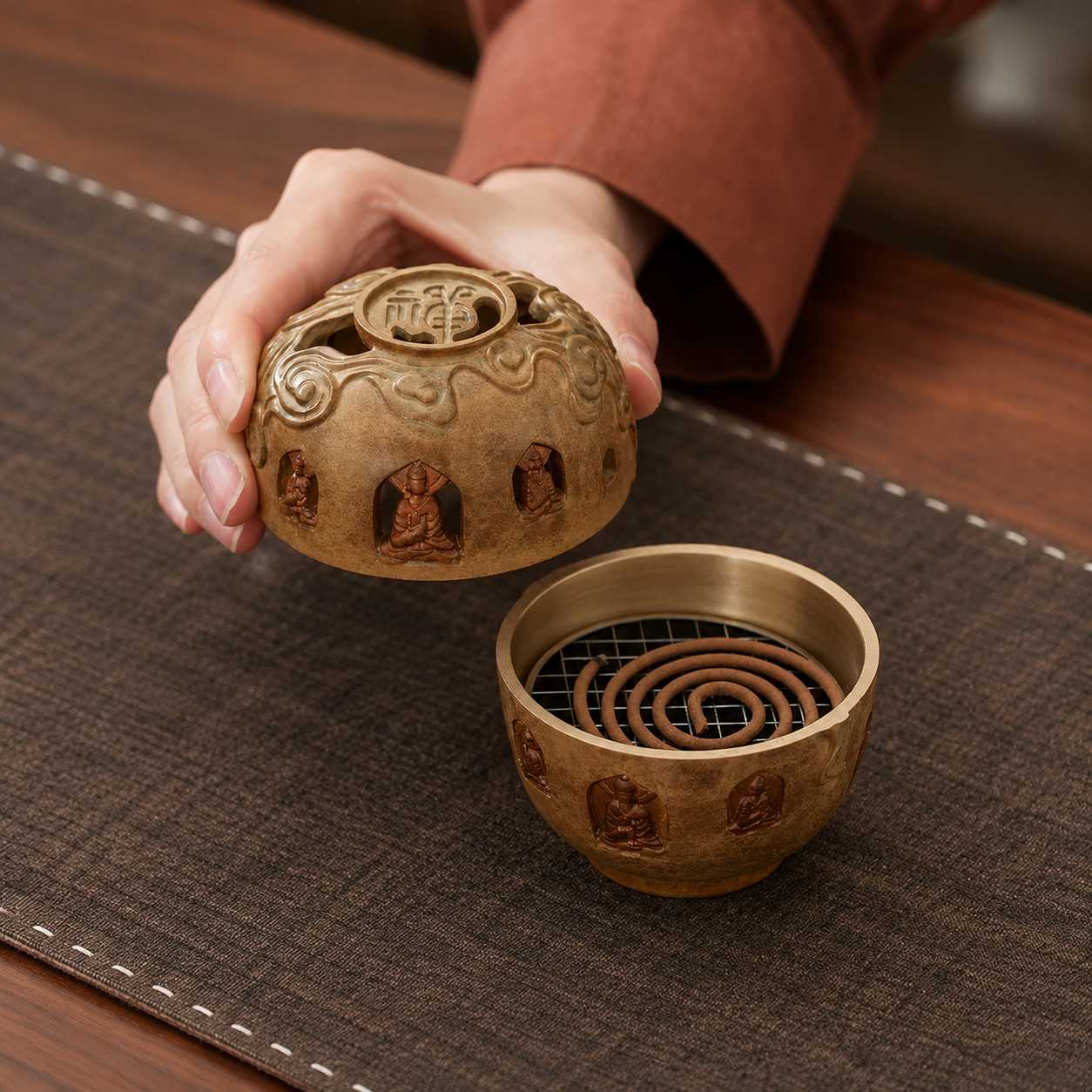 Buddhist incense burner with carved Buddha figures and spiral incense coil for mindfulness practice