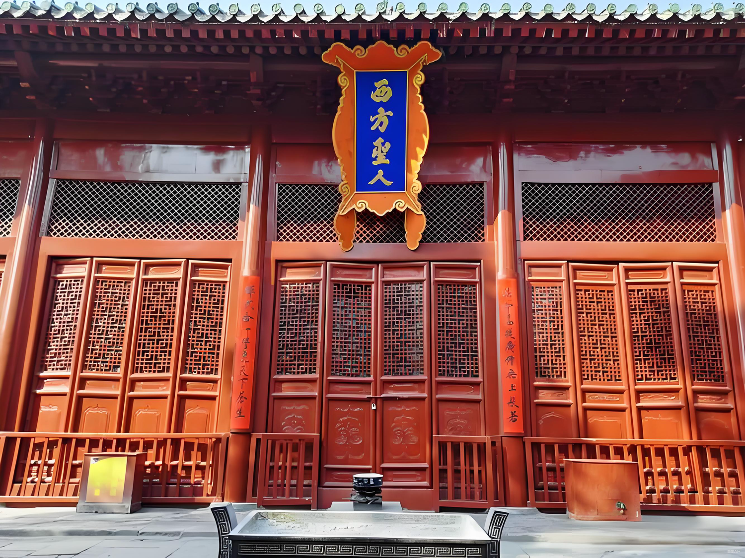 Traditional Chinese temple entrance with ornate red wooden doors and incense burner