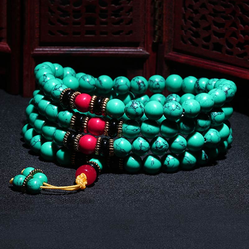 Turquoise Buddhist prayer beads with red and black accents, ideal for mindfulness and meditation practice.