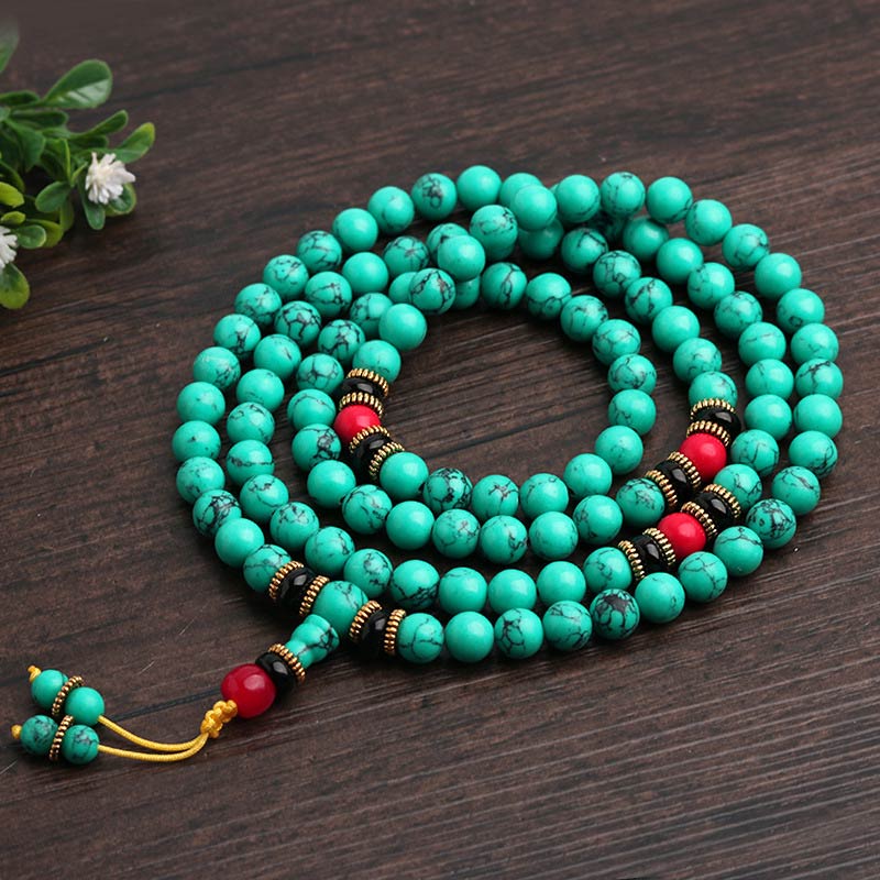 Turquoise prayer beads with red accents for Buddhist meditation and mindfulness practice