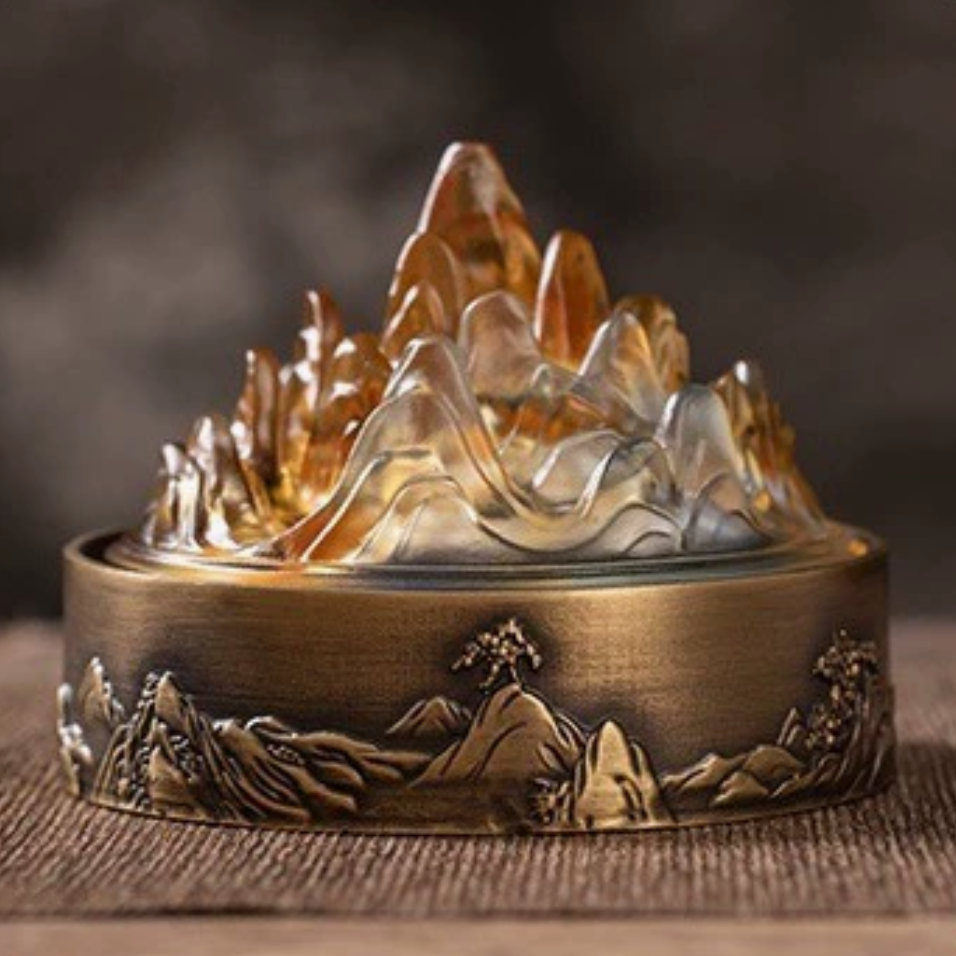 Mountain-shaped incense burner with flowing smoke, bronze base, Buddhist altar decor