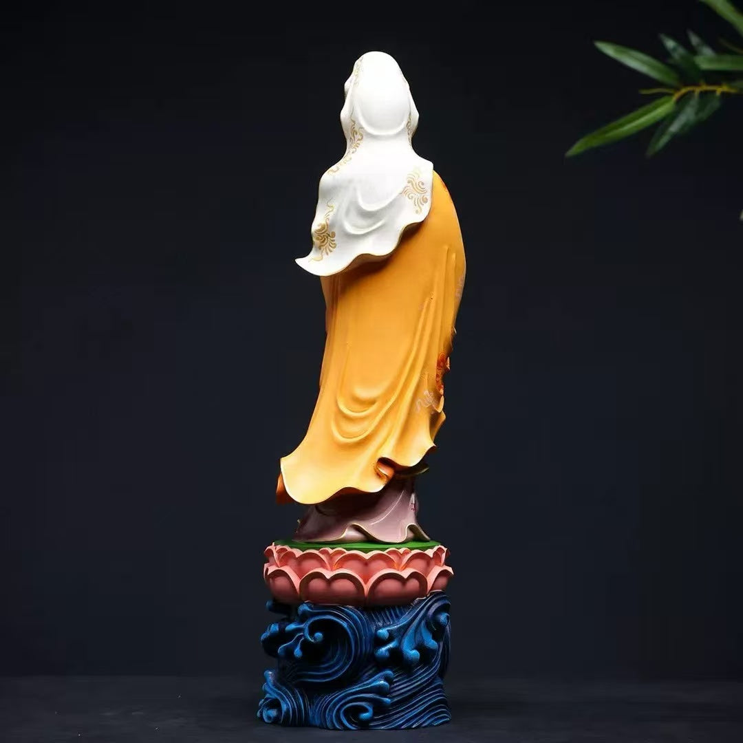 Buddha statue with golden robe and white hood, standing on lotus base with blue waves, for mindfulness and altar decor