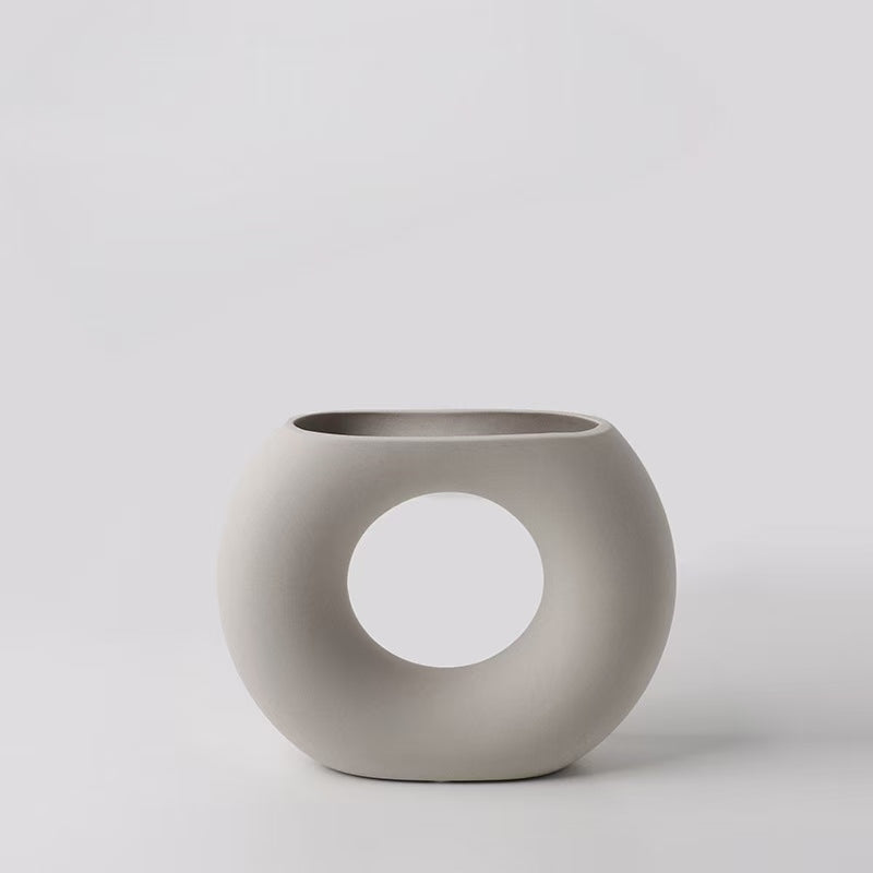 Minimalist gray ceramic vase with circular cutout for altar decor and mindfulness