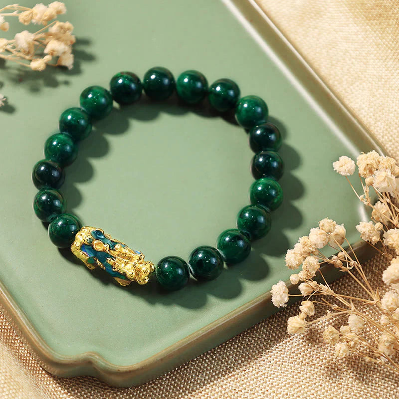 Green malachite prayer beads with golden Buddha charm, ideal for mindfulness and peace
