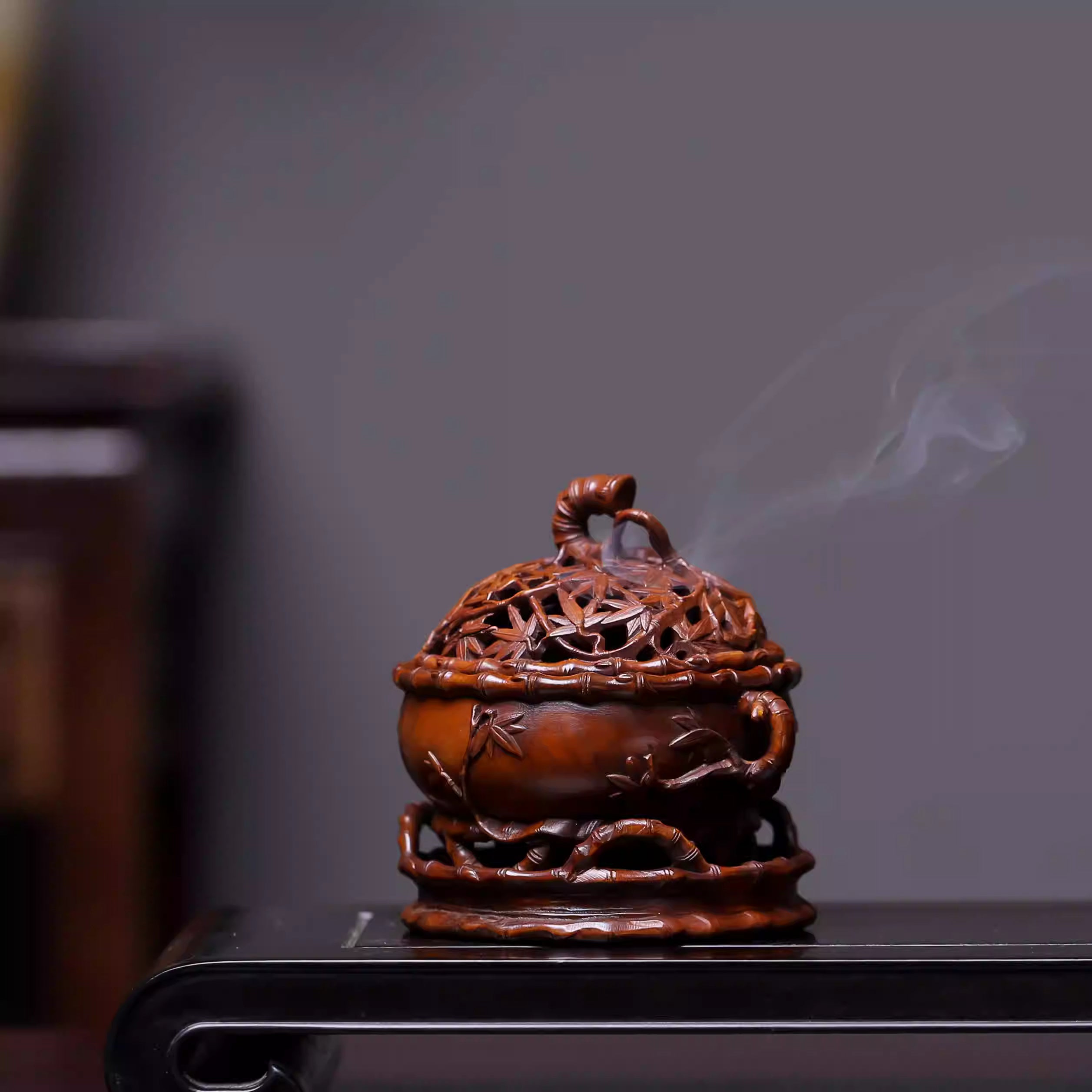 Hand-carved bamboo incense burner with smoke, for Buddhist altar decor and mindfulness practice