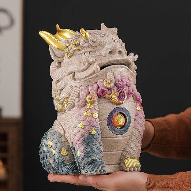 Hand holding colorful Pixiu statue with gold accents, Buddhist altar decor for mindfulness and peace