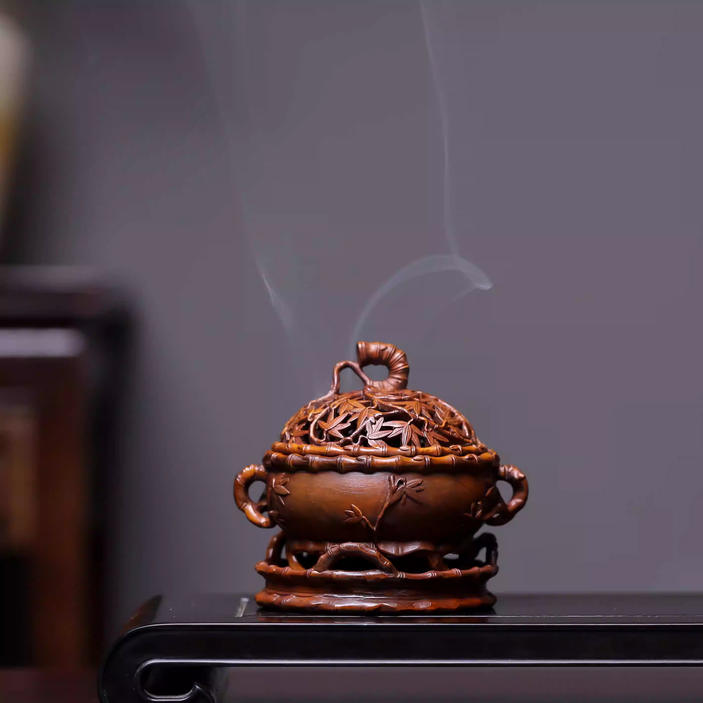 Bamboo-carved incense burner with smoke, for Buddhist altar decor and mindfulness practice