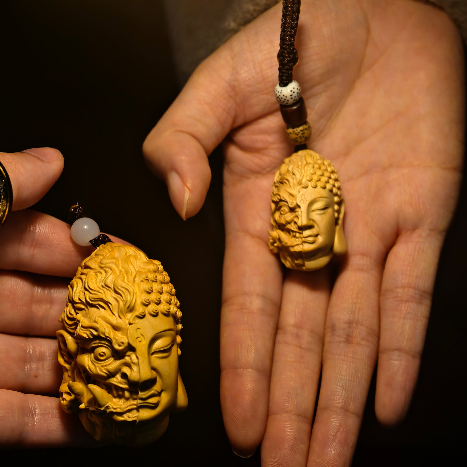 Hand-carved Buddha head pendant with dual serene and fierce faces, wooden amulet for mindfulness and spiritual balance