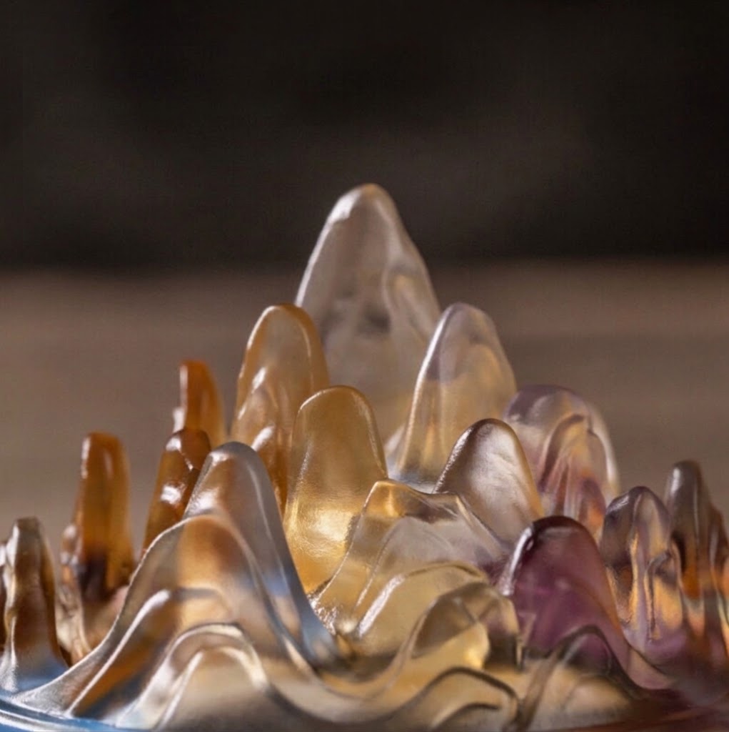 Translucent mountain-shaped incense burner with amber and purple hues for meditation and altar decor